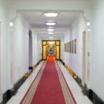 Hotelowy korytarz z luksusowym czerwonym dywanem i nowoczesnym oświetleniem